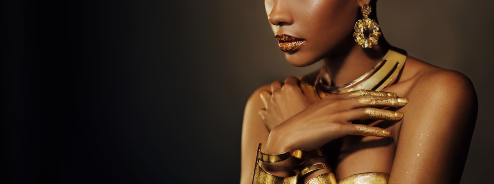 Cropped Portrait of a woman with gold makeup