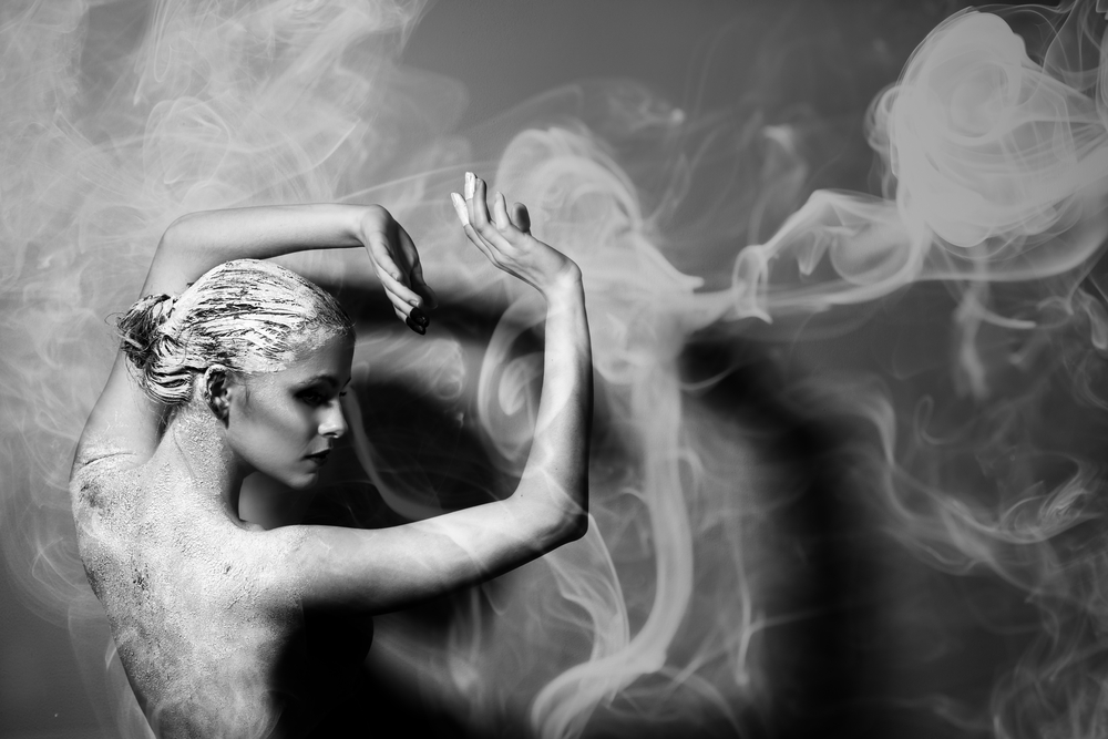 nude Woman covered in clay with some smoke