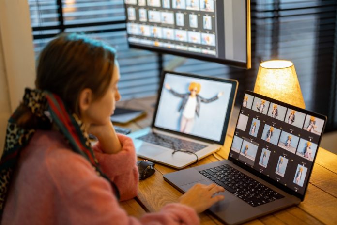 Photographer editing photos on her computers