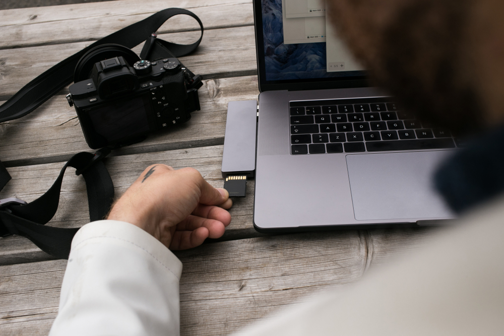 Photographer transferring images to a computer from and SD Card
