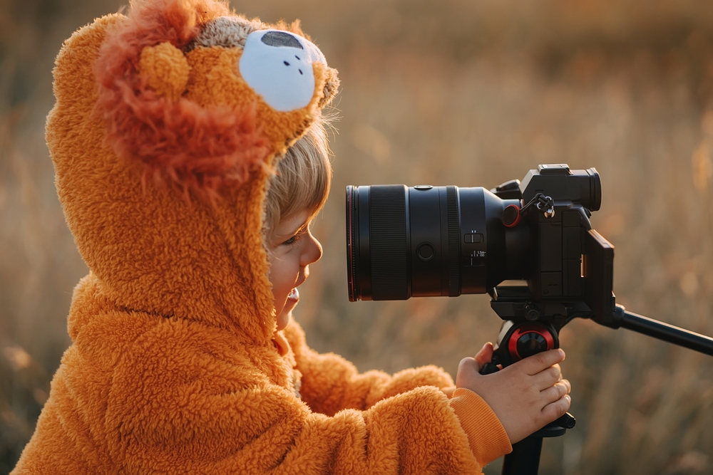 toddler boy in orange lion costume smiling