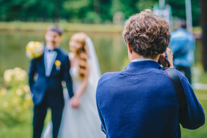 wedding photographer takes pictures of the bride and groom