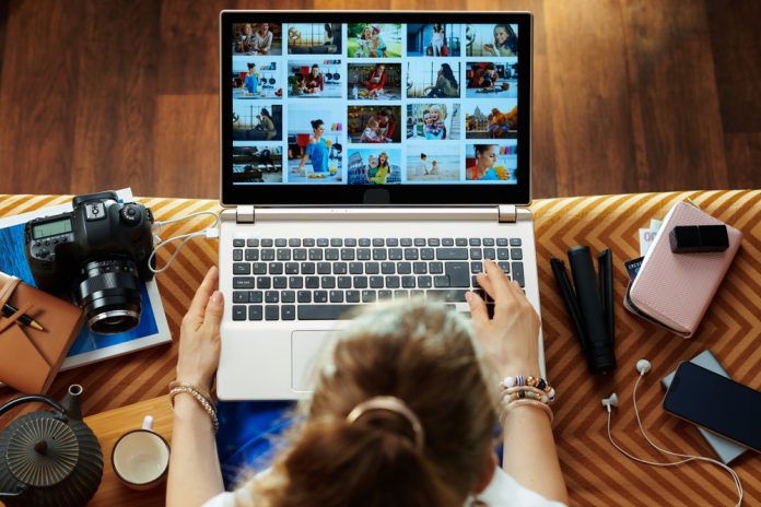 woman sitting on couch editing photos
